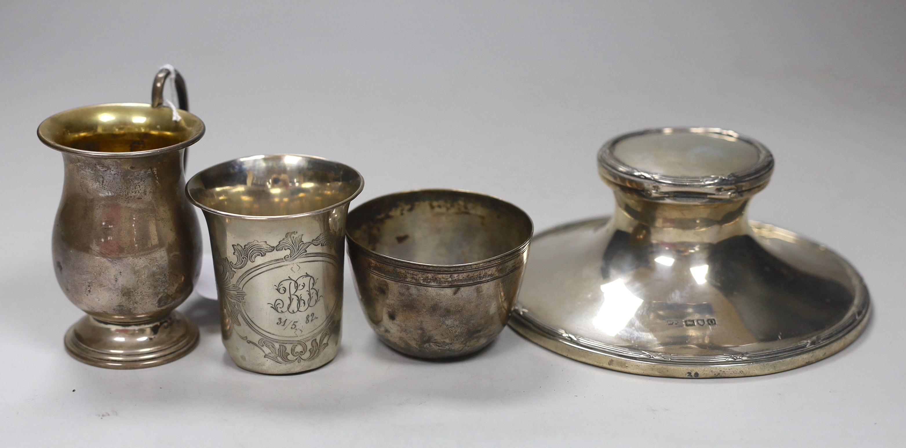 Assorted silver and white metal items including capstan inkwell, mug, photograph frame, cased and loose flatware, anointing spoon replica, beakers etc.